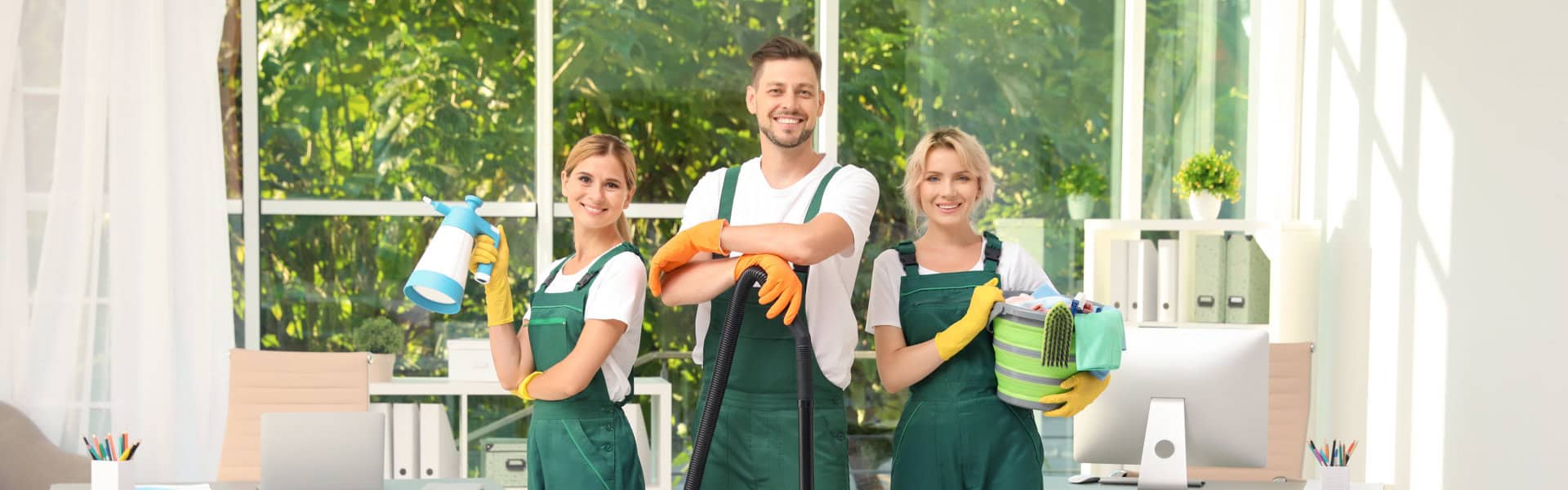 group of people smiling while cleaning